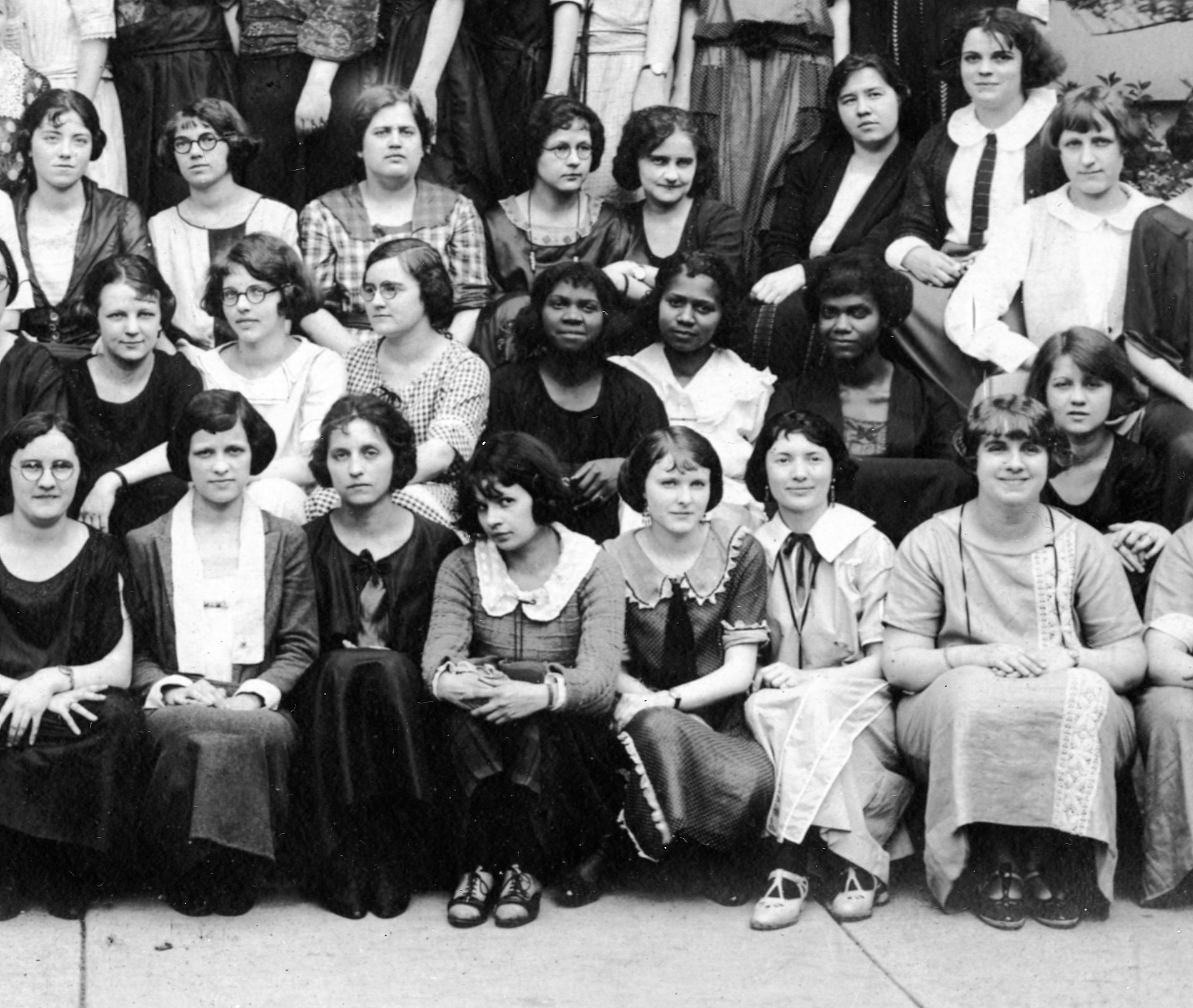 A cropped view of an unidentified class photo from Butler University, centering on three Black women surrounded by white women.