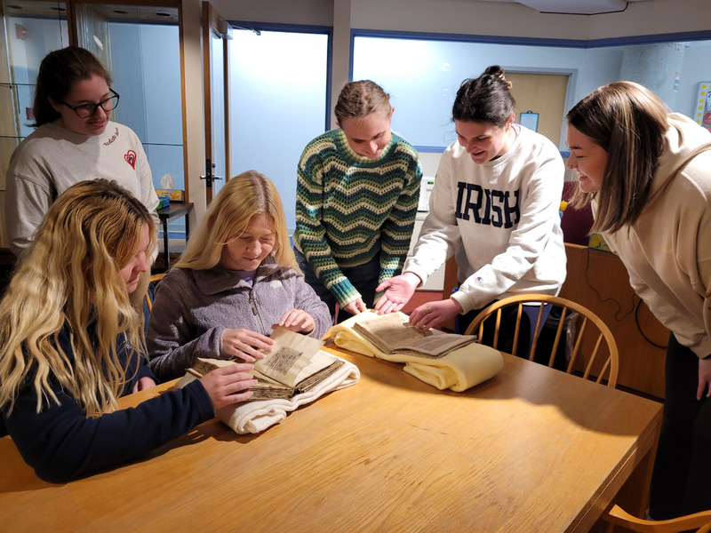 dcterms:description: Students examining two medieval manuscripts housed in Saint Mary's collection

iptc:By-line: Sarah Noonan

dcterms:date: April 23, 2023