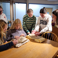 dcterms:description: Students examining two medieval manuscripts housed in Saint Mary's collection

iptc:By-line: Sarah Noonan

dcterms:date: April 23, 2023